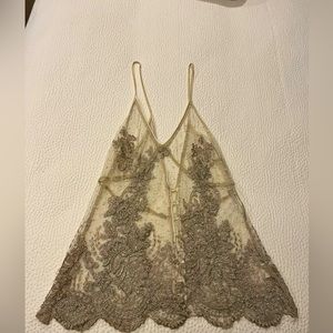 Lace embroidered tank top, goes over a solid tank, hits at the natural waist